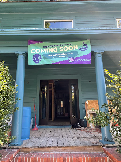 The Auroraflow storefront, a turquoise porch in downtown Durham with a 'Coming Soon' banner