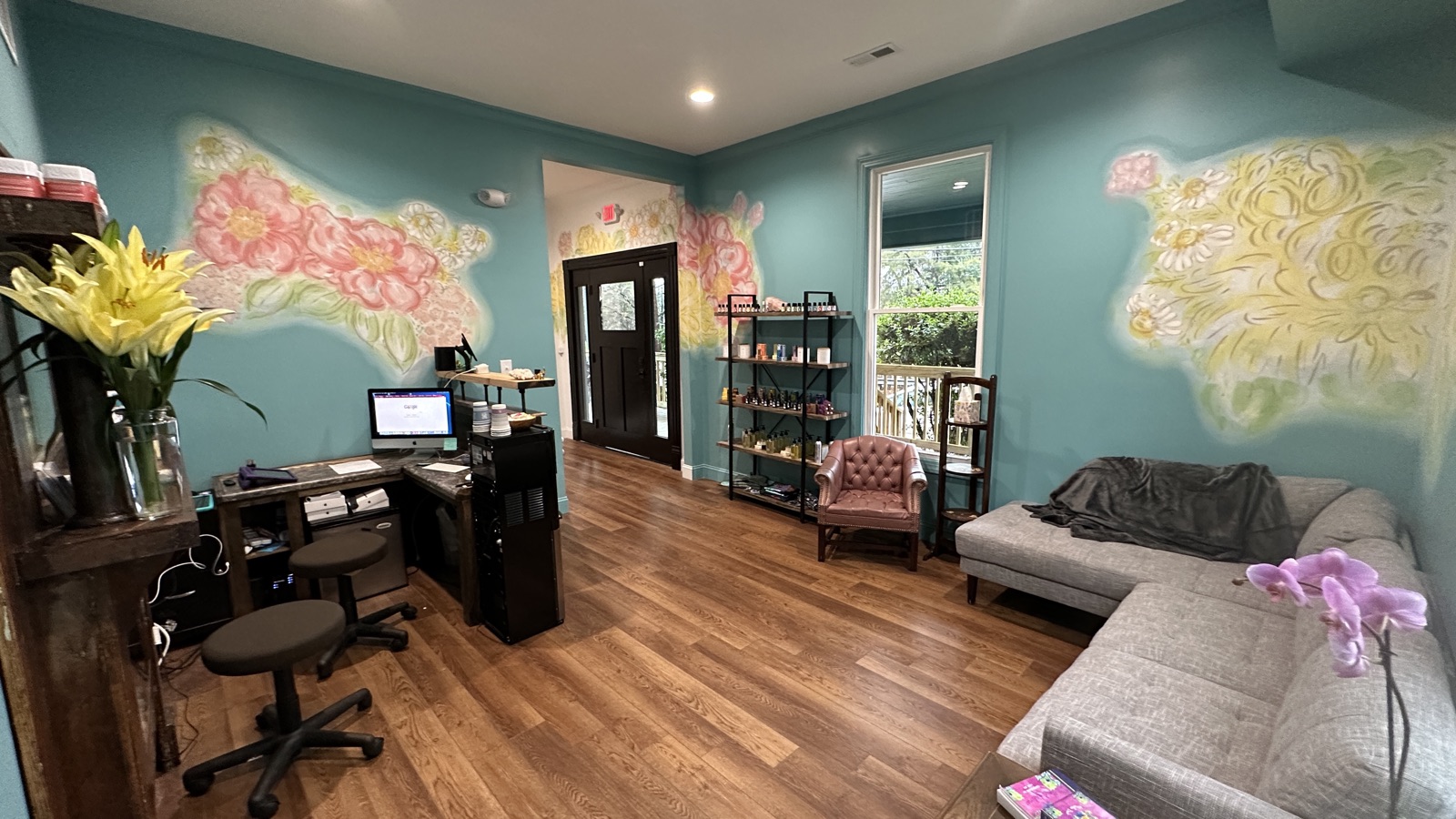 Auroraflow reception area with floral murals
